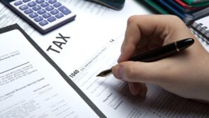 $1 billion in unclaimed 2021 child tax credits will expire in weeks 17 Child Tax Credit, hand, pen, calculator, tax forms