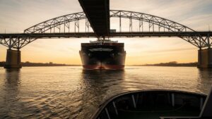A 1,000-foot ship passes under a 96-year-old bridge over the Columbia River with potentially less than 14 inches to spare, and the invisible force that changes that gap every single day is stranger than the vessel itself 29 a cargo ship passing under a river bridge with minimal ship clearance, 1 000 foot