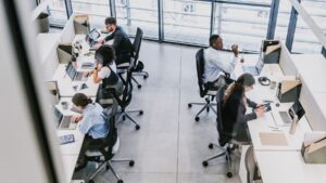 Millions of Americans spend their days in dimly lit offices, and a Nobel Prize winner says that is the real threat their body clock has been facing all along 14 a desk bathed in fluorescent light beside a sunlit window showing circadian clock contrast, americans spend their