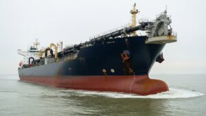 A 730-foot ship named after Columbus can carry 46,000 cubic meters of sand in a single run, and the living city hiding in that seabed before the suction pipe arrives is something almost no engineer on the bridge ever stops to picture 49 world's largest hopper dredger cutting through grey ocean water from a low angle, 730 foot ship