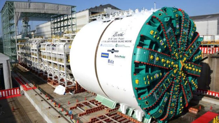 Built to chew a 2 mile tunnel under downtown Seattle, a 7,000 ton machine named "Bertha" spun a 57 foot cutting face for barely 1,000 feet before her main bearing overheated and left her stuck underground for two years 1 Bertha Heavy Machinery