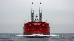 A cargo ship set sail with two 123 foot steel wings bolted to its deck, and the force pulling 80,000 tons of grain across the Pacific is the same one that lifts an airplane off the ground 10 cargo ship wind wings rising above ocean swells on grey open sea, cargo ship set