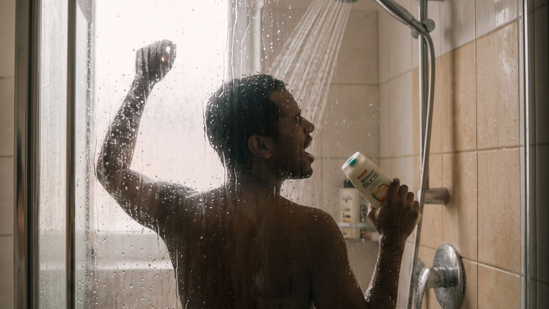 A person shower singing behind a steamy glass shower door