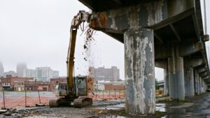 Syracuse counted 8 of every 9 of its Black residents in one ward, and the I-81 viaduct built through it in the sixties is coming down under a contract that costs more than the whole project was budgeted at 34 Demolition beginning beneath the I-81 viaduct in downtown Syracuse