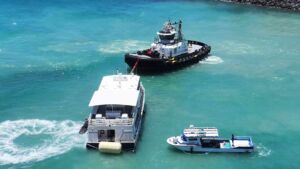 A 75 foot tour boat sat on the reef 60 feet outside a Honolulu harbor mouth for 10 days, but the coral it came down on was already so thin that the damage was mostly to bare rock 40 Grounded tour boat pressed against the Kewalo reef with damaged coral in the foreground, 75 foot tour