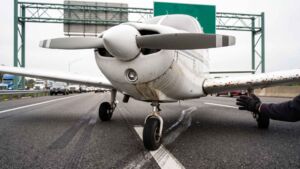 A flight instructor aged 21 lost oil pressure over Florida and put a training plane down on the eastbound lanes of an interstate, passing under an overhead sign with a student on his first lesson aboard 50 Training plane stopped on an interstate under a highway sign