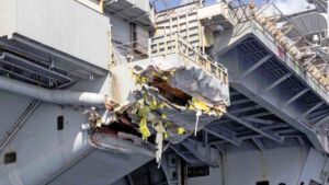 An aircraft carrier approaching one of the world's busiest shipping chokepoints at night was still making 19 knots when its own plan called for 5, and investigators found the resulting collision with a bulk carrier was avoidable 27 Torn hull plating of an aircraft carrier after the carrier Port Said collision, viewed from a small boat, aircraft carrier approaching