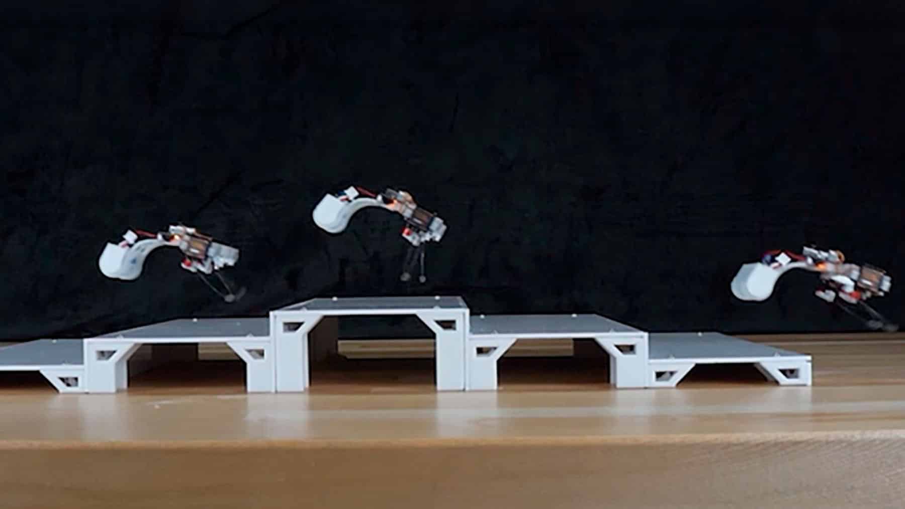 Inspired by frogs a tiny robot uses snapping elastic rods to hop across sand glass and water without draining its motor