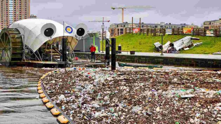 Baltimore trash wheel lifting sports balls and debris from the harbor water, baltimore pulled 63