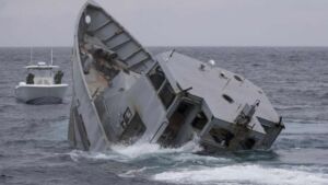 Crews pulled two levers on a derelict 120-foot torpedo retriever stuck for years in a South Carolina marsh and sank it about 32 miles offshore, where spotted dolphins circled the site within minutes 16 Navy torpedo retriever reef sinking off South Carolina coast with crew watching from tug, crews pulled two