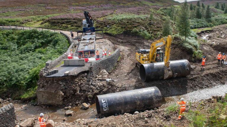 Wind farm steel tubes rolled into a flooded Yorkshire Dales stream as an emergency bridge, floodwater tore out