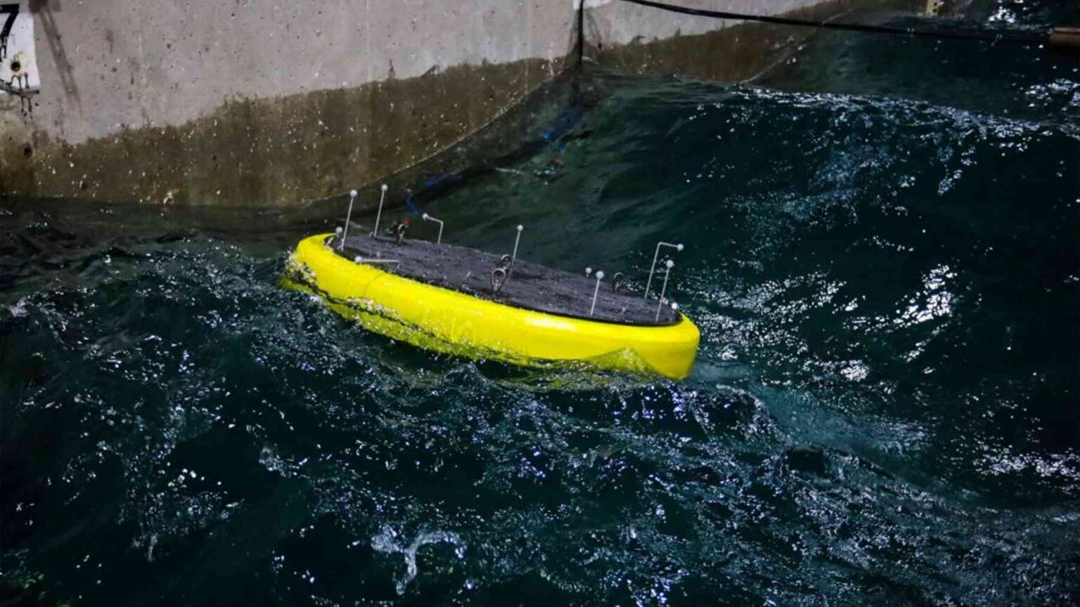 A lab scale wave energy buoy rides a 342 foot indoor wave channel in ...