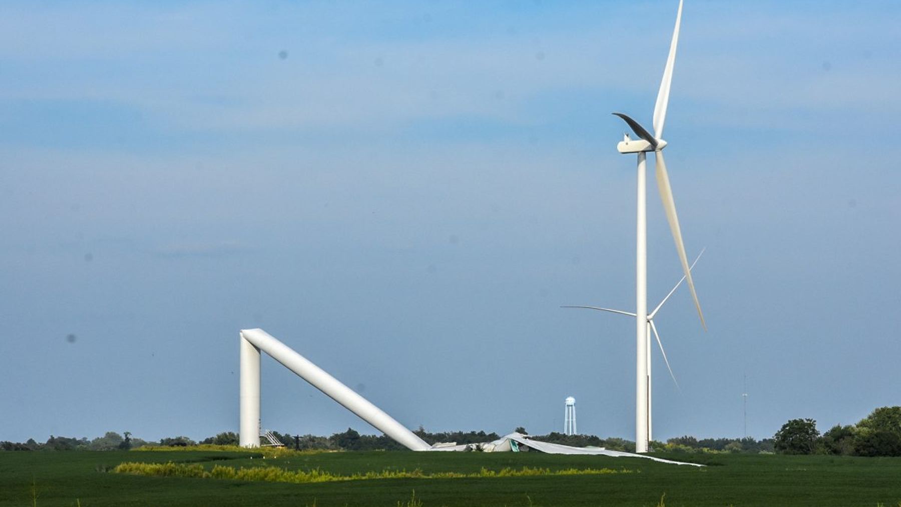 Collapsed wind turbine tower folded across a Missouri field after turbine collapse, same wind farm