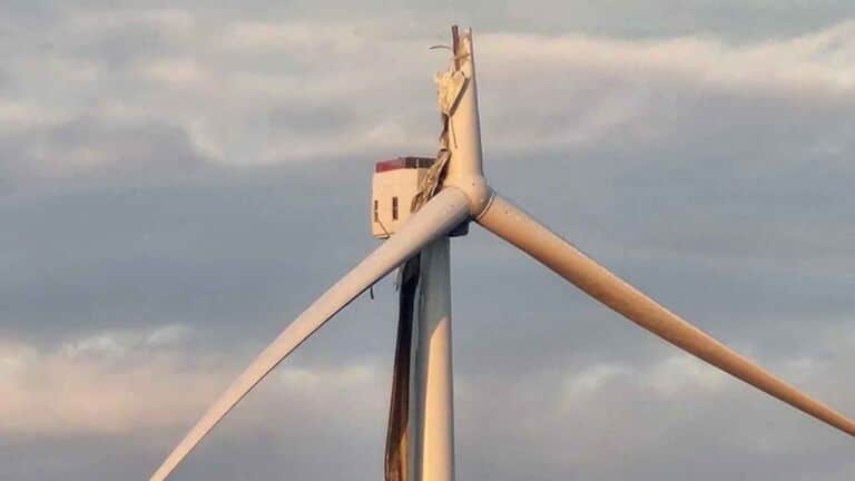 Wind turbine missing a blade at a Swedish wind farm after repeated blade failures, technicians drive past