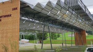 A folding roof of panels drawing shut above a sewage tank